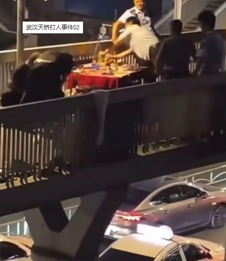 Three urban management assistants detained after Wuhan overpass clash